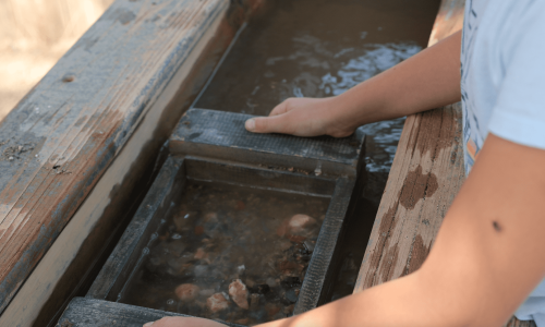 Close up of a child panning for gemstones at 1880 Town